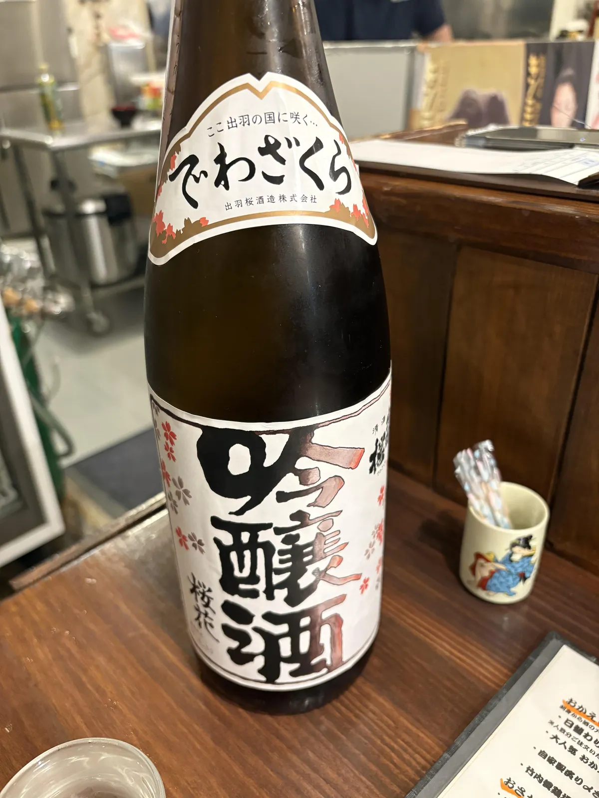 出羽桜 桜花吟醸酒の一升瓶。ラベルには桜の花びらが描かれている